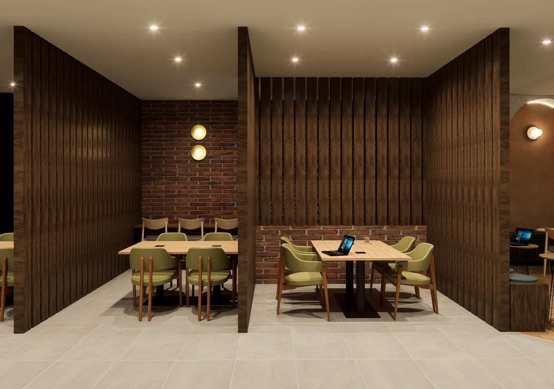 Cabinas y mesas de trabajo del coworking entre paneles de madera y ladrillo.